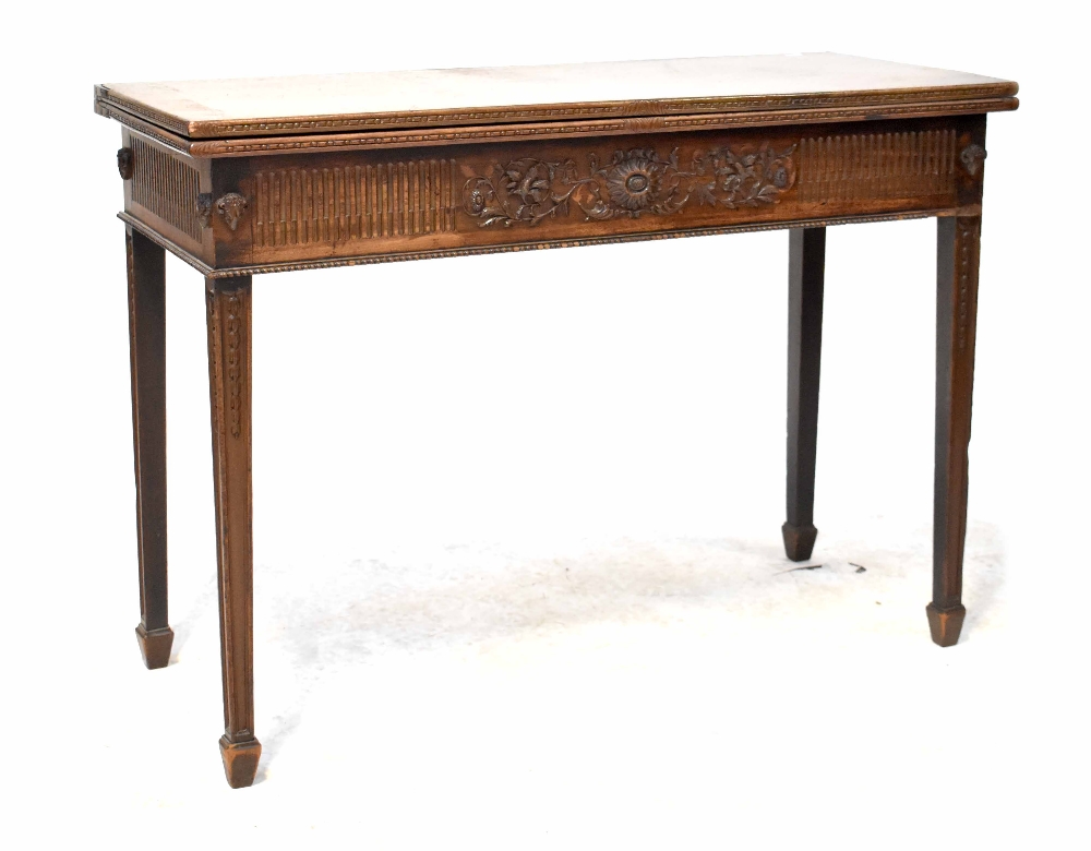 A good 19th century mahogany tea table of rectangular form with fold-over top and carved frieze