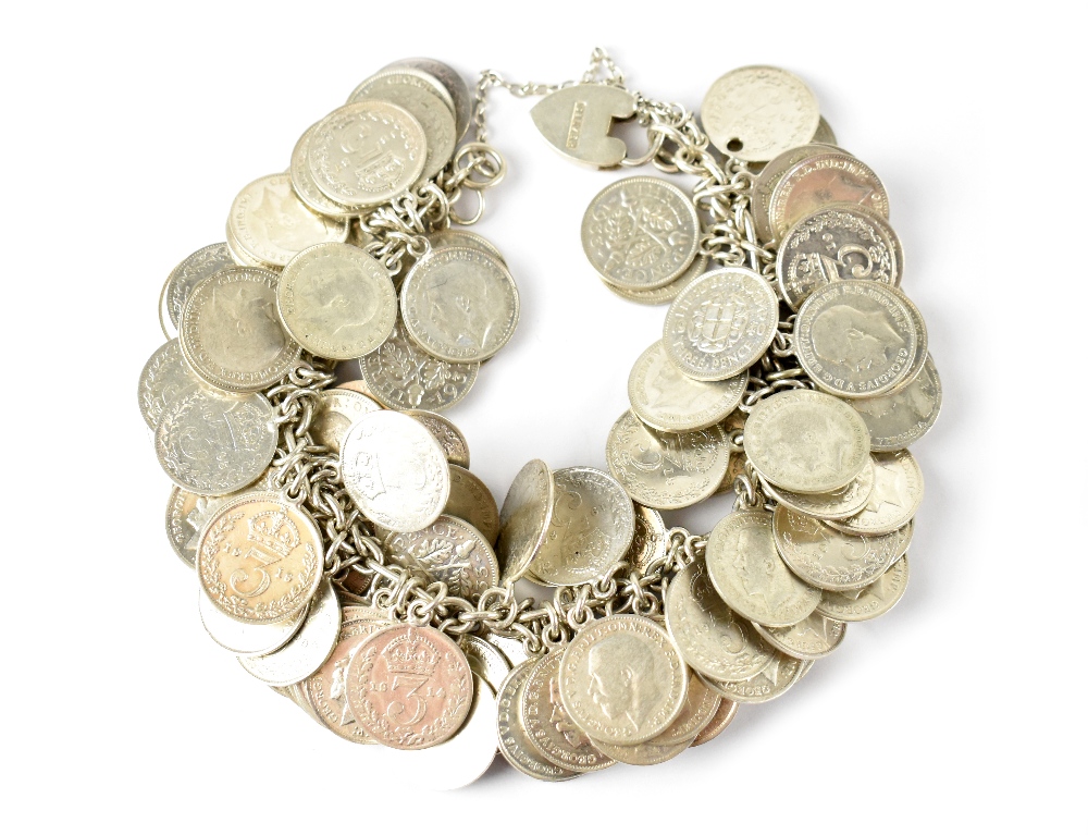 A heavy coin bracelet comprising of silver and half silver 3p coins on silver chain with silver