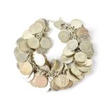A heavy coin bracelet comprising of silver and half silver 3p coins on silver chain with silver