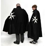 Two Order of St. John cloaks with applied emblems and red linings, length 130cm (2).Additional