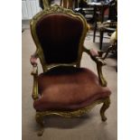 A French style gilt open armchair with upholstered back, arm rests and seat, on cabriole supports.