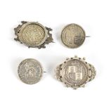 Four Victorian and Edward VII silver coins made into brooches, two with surrounding mounts, approx