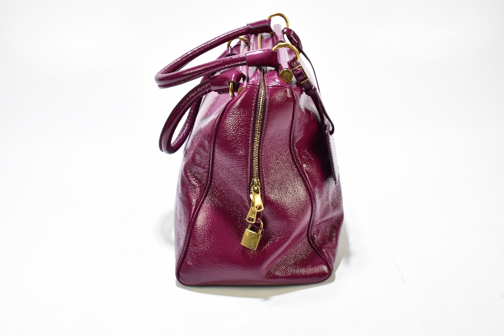 YVES SAINT LAURENT; a large claret coloured 'Muse' gloss patent leather messenger handbag with - Image 4 of 6