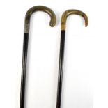 Two horn handled walking sticks/canes, the larger with white metal collar initialled, length 91cm,