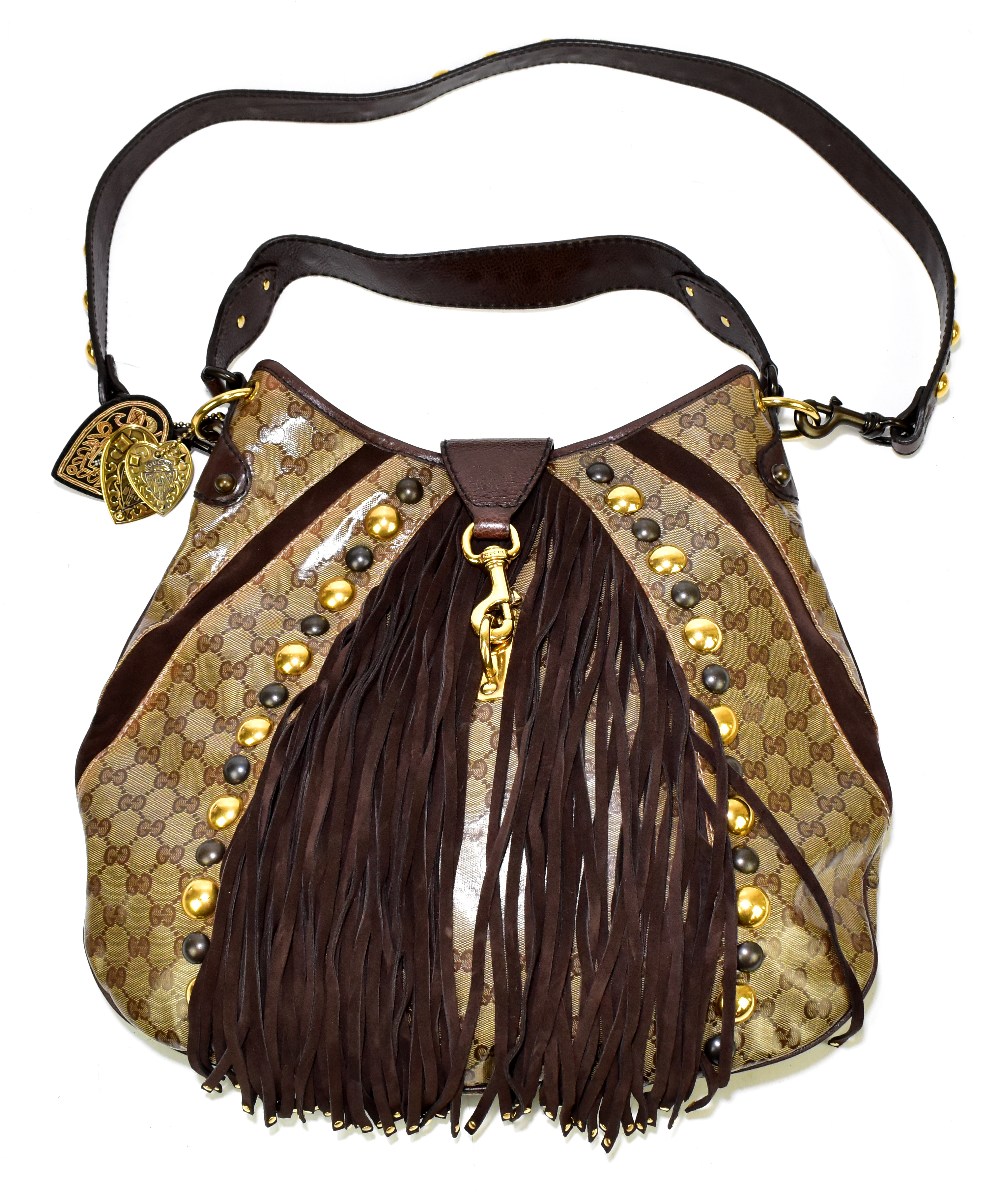 GUCCI; a large monogram cloth handbag with brown suede and leather hand and shoulder straps,