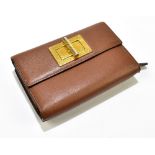TOM FORD; a brown leather wallet and purse, the wallet contains ten card holders, a separate coin