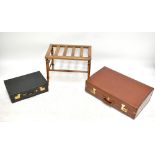 Two vintage stitched leather suitcases with brass fittings, the smaller stamped 'Finnigans,