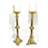 A pair of Victorian style brass ecclesiastical candlesticks, with applied and cast stylised