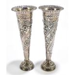 A pair of Victorian hallmarked silver posy vases with repoussé floral decoration, London 1896,