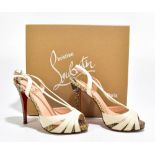CHRISTIAN LOUBOUTIN; a pair of cream leather 'Activa' strappy stiletto sandals with python leather