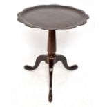 A modern occasional table with piecrust top on tripod supports, height 63cm, diameter 56cm.