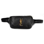 YVES SAINT LAURENT; a black lambskin leather waist/bum bag with gold tone 'YSL' details to front,