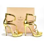 PRADA; a pair of gold leather strappy stiletto sandals with a 13cm heel and 2cm wedge, zip to back