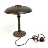 A 1970s bronzed metal desk lamp with circular top raised on single column terminating on stepped