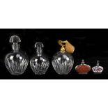 BACCARAT; a three-piece glass dressing table set comprising two perfume bottles and an atomiser,