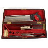 A 19th century mahogany and brass bound cased surgeon's kit including saw, three graduated blades,