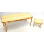 Two modern French style cream painted serpentine coffee tables, raised on carved cabriole
