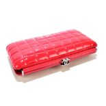 CHANEL; a square quilted kiss lock framed clutch bag in red patent leather with vermilion