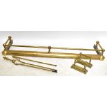 A brass fender, width 135cm, a pair of andirons, tongs and a poker. Additional InformationDents,