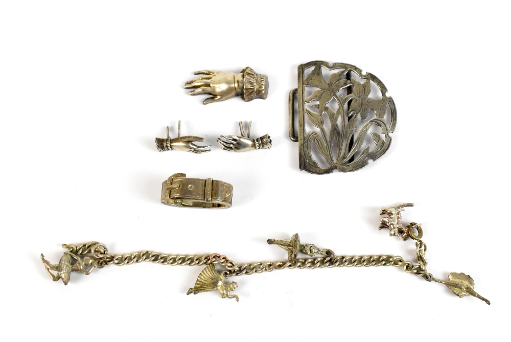 Three late 19th/early 20th century silver brooches/pins modelled as hands, a scarf clip modelled
