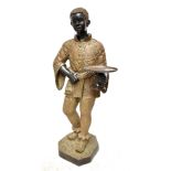 A large modern patinated and gilt painted metal blackamoor figure modelled holding a tazza on