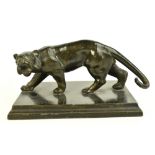 An early 20th century bronzed spelter model of a stalking tiger, raised on stepped plinth base,