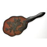 A Chinese ebonised hand mirror with carved floral detail, length 25cm.