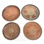 Four Eastern circular copper trays with stylised engraved decoration, the larger diameter 38cm (4).