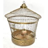 A gilt metal bird cage containing a model bird, height 50cm, diameter at widest part 45.5cm.