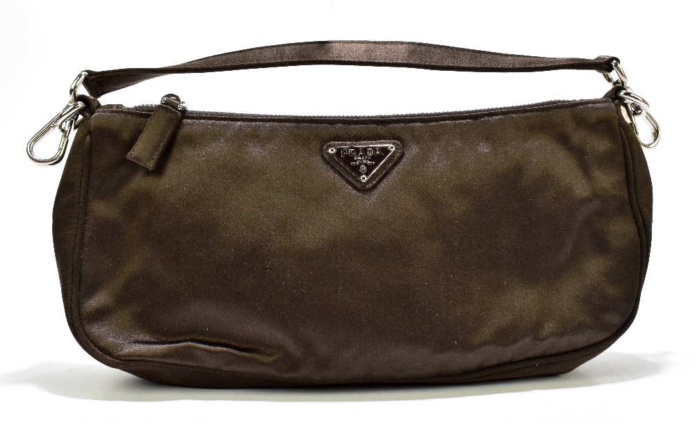 PRADA; a brown satin shoulder bag/clutch with silver tone hardware, a zip top and detachable strap