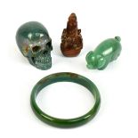 Three pieces of hardstone to include a carved skull, a bangle, also a wooden carved snuff bottle (