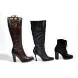 YVES SAINT LAURENT; a pair of brown leather heeled and small platformed boots with a silver tone