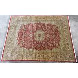 A good and large hand knotted Indian silk cream ground carpet work floral decoration within red