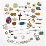 An interesting collection of silver and white metal jewellery, predominantly brooches, some with a