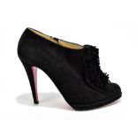 CHRISTIAN LOUBOUTIN; a pair of black suede ankle boots with stiletto heels, fringe to the front,