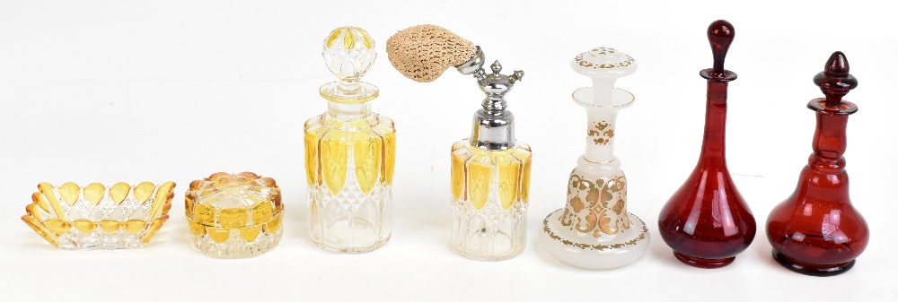 An early 20th century Bohemian milk glass perfume bottle and stopper, with relief gilded floral