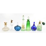 Seven assorted glass perfume bottles and atomisers including two iridescent examples, one with '