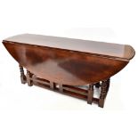 A good reproduction oak drop leaf gate leg wake/hunt table on ring turned and block supports, height