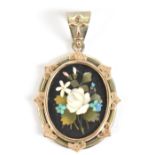 A 19th century white metal and rose gilt oval pendant featuring Ashford black marble inset with