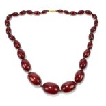 A cherry amber graduated oval bead neckalce with simple screw clasp and hand tied string, length