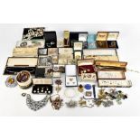 A collection of costume jewellery including a large Scottish brooch with amber coloured glass stone,