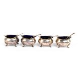 GEORGE WISH & CO LTD; a cased set of four Victorian hallmarked silver salts with blue glass