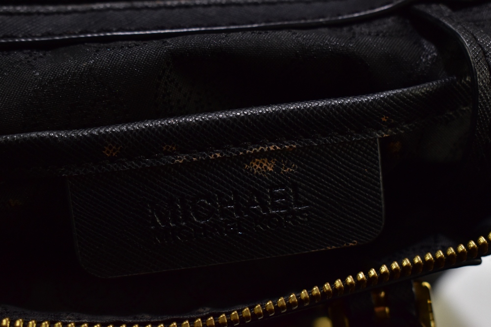 MICHAEL KORS; a black jet set leather tote bag with gold tone hardware base studs, zip, buckles - Image 5 of 7