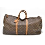 LOUIS VUITTON; a circa 1980s vintage brown monogram Keepall Bandoliere 60 (lacking shoulder strap).