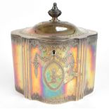 A George III hallmarked silver tea caddy of shaped oval form with chased decoration surrounding an