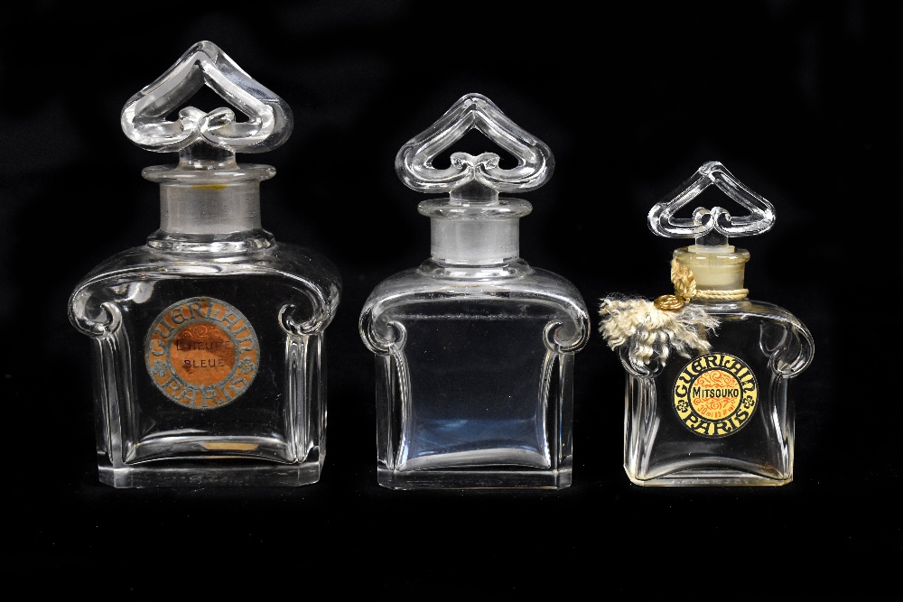 BACCARAT; three clear glass 'Guerlain' perfume bottles including a cased example, two complete