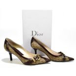 DIOR; a pair of brown leather and canvas stiletto court shoes with iconic crossover buckle and