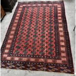 A Bokhara-type rug on coral and navy grounds, approximately 260 x 190cm.Additional InformationSome