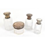 A set of four French silver topped clear glass vanity jars, the tallest height 13.5cm, silver approx