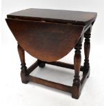 A reproduction oak drop leaf occasional table on turned and stretchered supports, height 47.5cm,